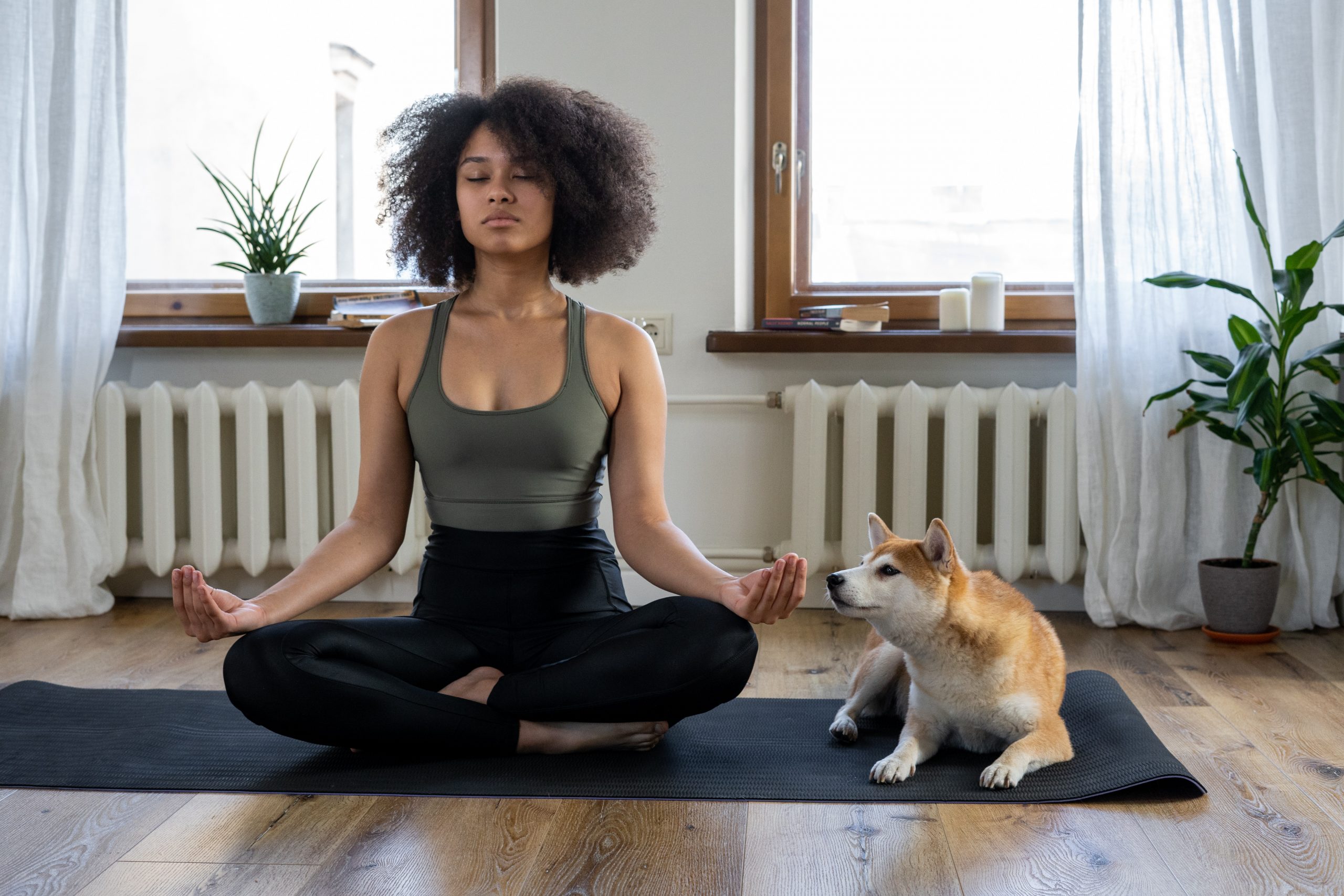 woman meditating with dog